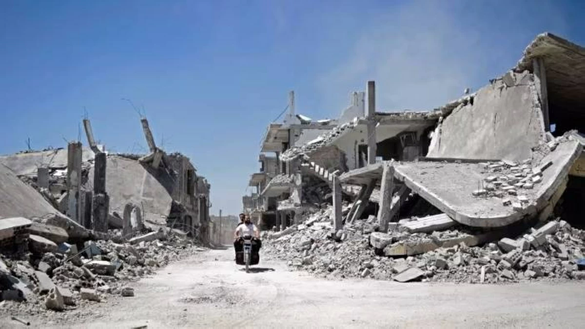 Syrian men ride a motorcycle in Homs.
(AFP photo)