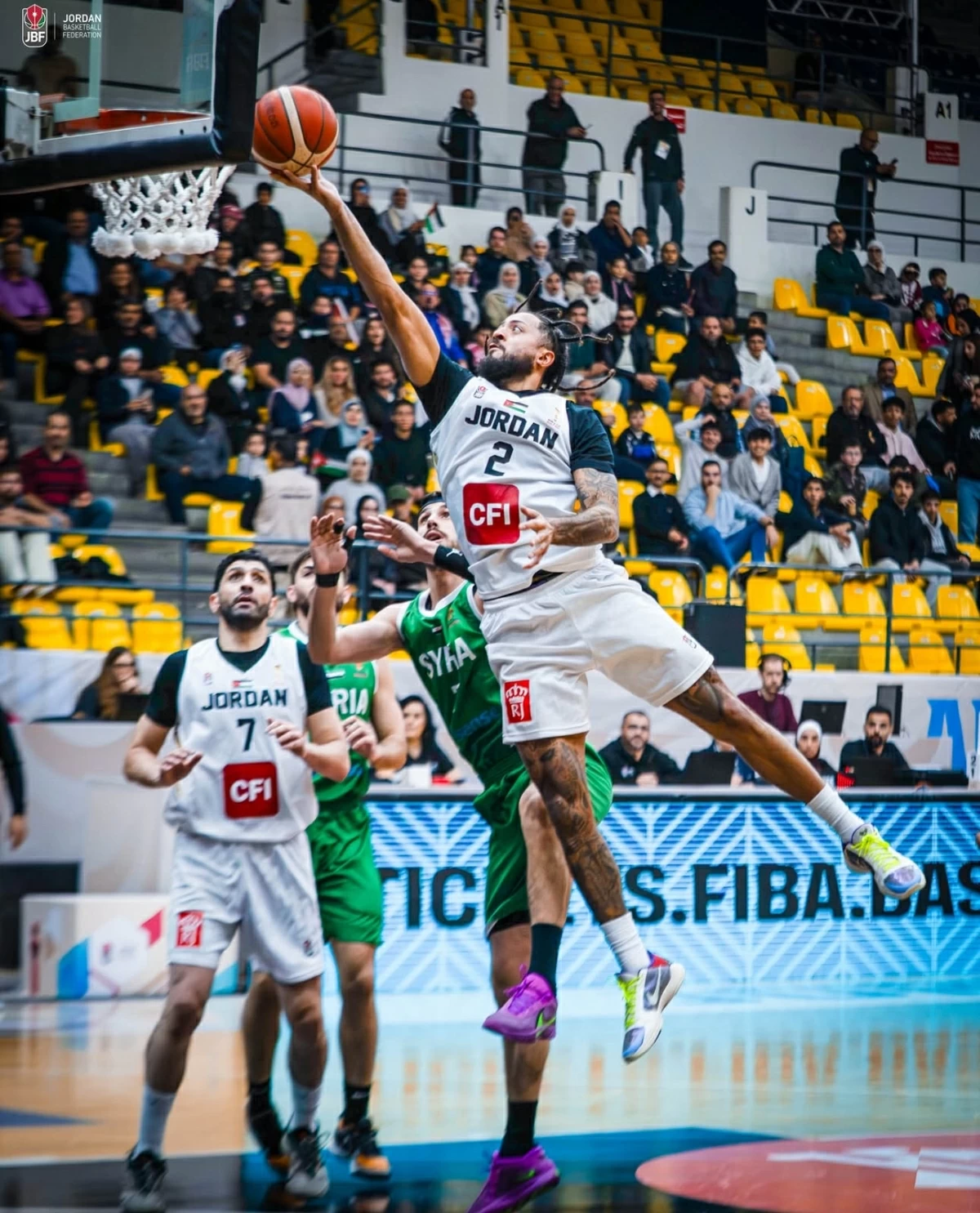 Ahmad Hamarsheh (#7) guards Jalen Harris as he scores for Jordan and writes FIBA World Cup qualifying records 
(Photo courtesy of JBF)