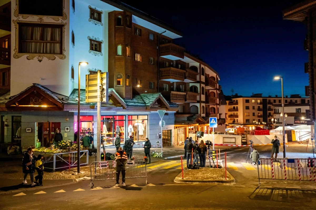Journalists gather in front of the street where a fire ripped through a crowded bar during New Year's Eve celebrations in the Alpine ski resort town of Crans-Montana on Thursday (AFP photo)