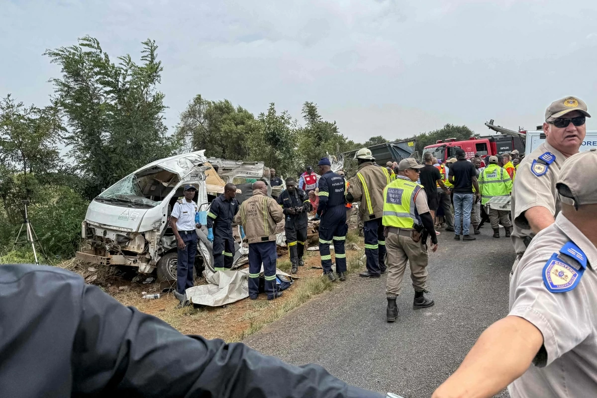 Rescue workers and South African Police Service (SAPS) forensic team members stand next to a covered body at the scene of an accident, where a minibus carrying school students collided with a truck killing 12 pupils, in Vanderbijlpark on January 19, 2026
(AFP photo)