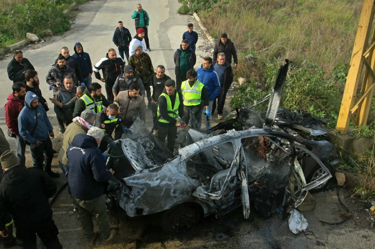Members from the team of First Aid Responders inspect the wreckage of a car at the site an Israeli airstrike in the southern Lebanese area of Zahrani on January 21, 2026 (AFP photo)