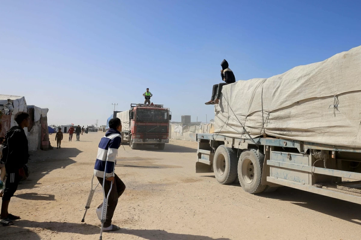 Palestinians look on as trucks carrying humanitarian aid arrive in Khan Yunis in the southern Gaza Strip, after passing through the Rafah border crossing from Egypt, on February 1, 2026
(AFP photo)