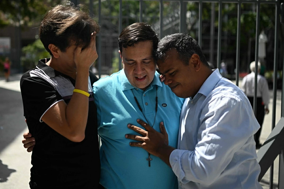 Human rights activist Javier Tarazona (centre) is greeted by his brother Jose Rafael Tarazona (left) and lawyer Omar de Dios Garcia after his release from prison at La Candelaria church in Caracas on Sunday (AFP photo)