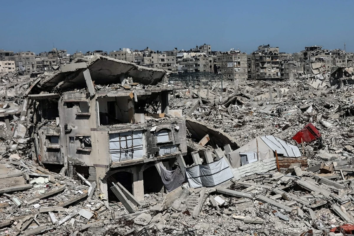 Tents housing displaced Palestinian families are erected between the rubble of homes and businesses destroyed by the Israeli military, in the Sheikh Radwan neighborhood of Gaza City on February 20, 2026 (AFP photo)