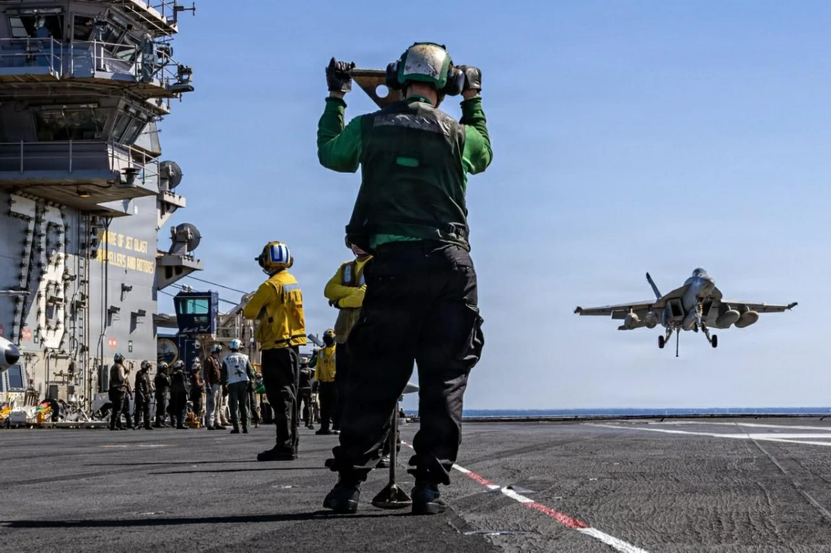 This US Navy handout photo released on March 18, 2026 by US Central Command public affairs, shows US sailors observing as an F/A-18E Super Hornet aircraft, assigned to Strike Fighter Squadron 31, approaches the flight deck of the world's largest aircraft carrier, USS Gerald R. Ford (CVN 78), during Operation Epic Fury, on March 8, 2026 (AFP photo)