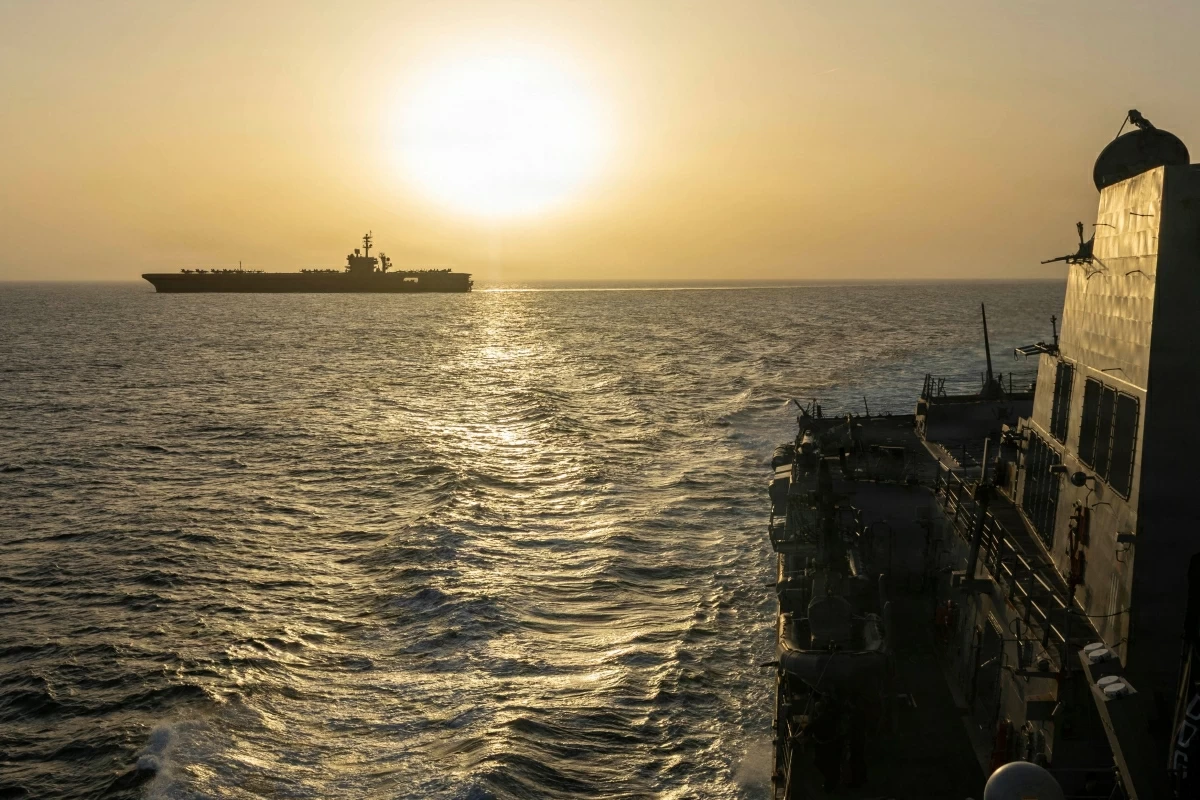 This US Navy handout photograph released on April 17, 2026, by US Central Command Public Affairs shows USS Abraham Lincoln (L) conducting blockade operations in the Arabian Sea on April 16, 2026 (AFP photo)