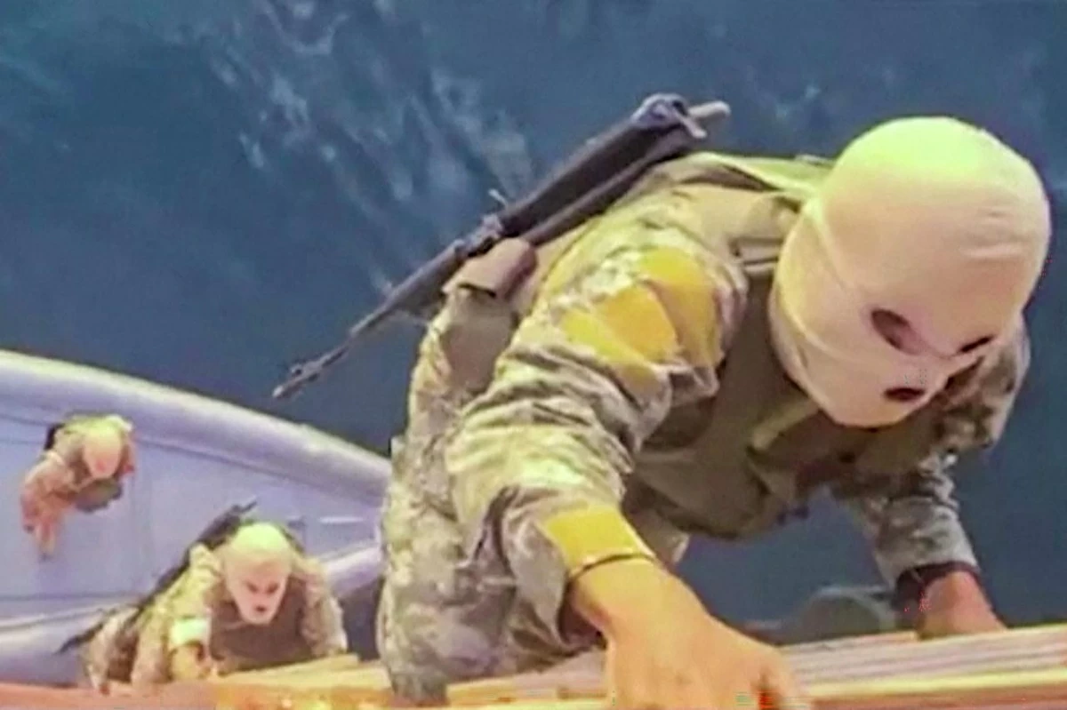 This screen grab taken from undated video footage released by Iran's Revolutionary Guards (IRGC) and made available via Iran's state broadcaster (IRIB) on April 23, 2026, shows IRGC naval forces allegedly boarding a ship attempting to cross the Strait of Hormuz (AFP)