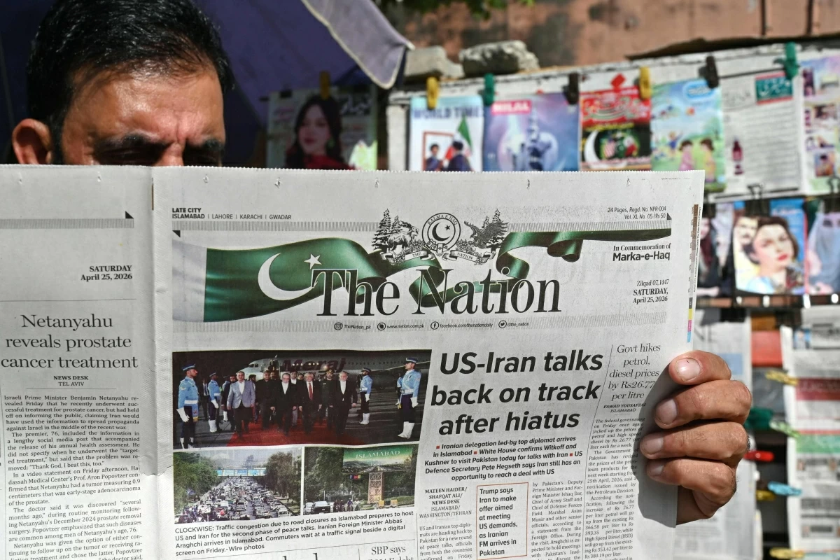 A man reads a newspaper at a roadside stall in Islamabad on April 25, 2026 (AFP photo)
