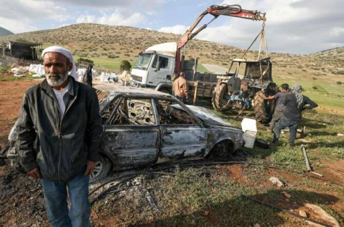 Palestinians inspect a burned vehicle and tractor following an Israeli settlers attack in the northen outskirts of Tayasir village near the occupied West Bank town of Tubas on March 31, 2026 (AFP photo)
