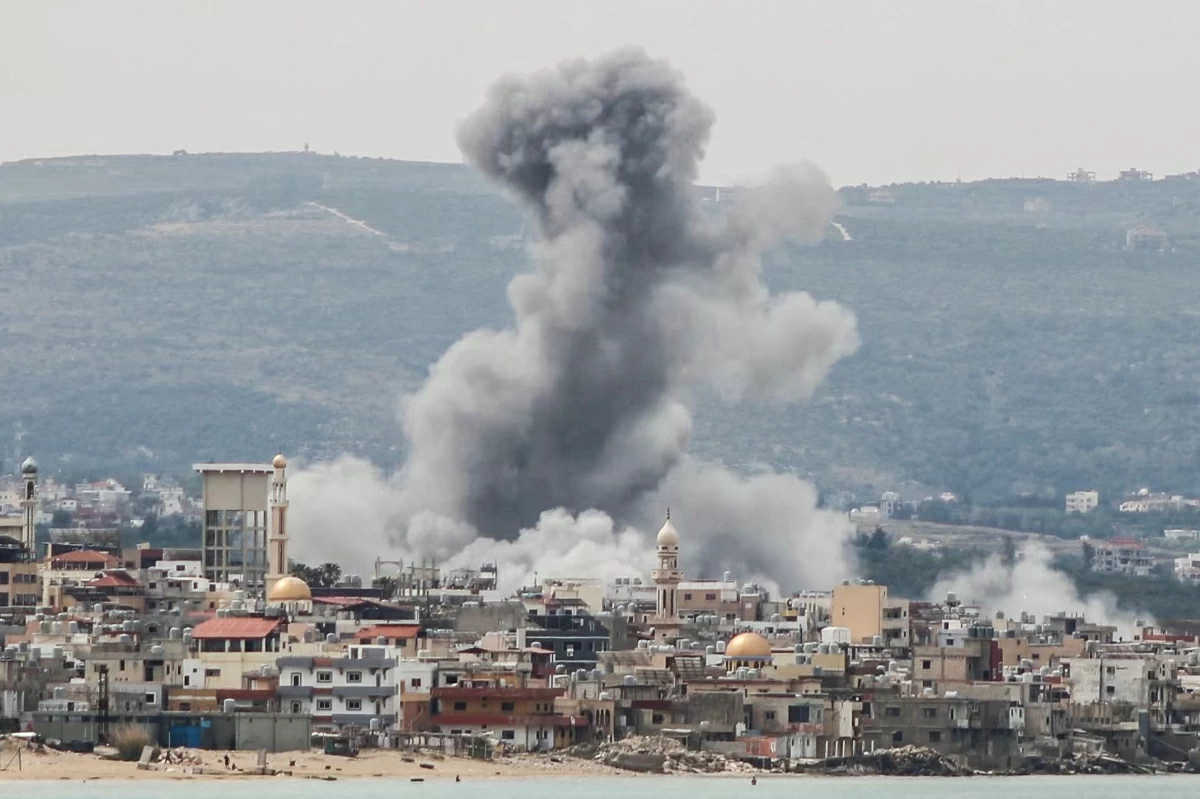A photograph taken from the southern area of Tyre shows smoke rising from the site of an Israeli airstrike that targeted the area of Ras Al-Ain on May 12, 2026 (AFP photo) 