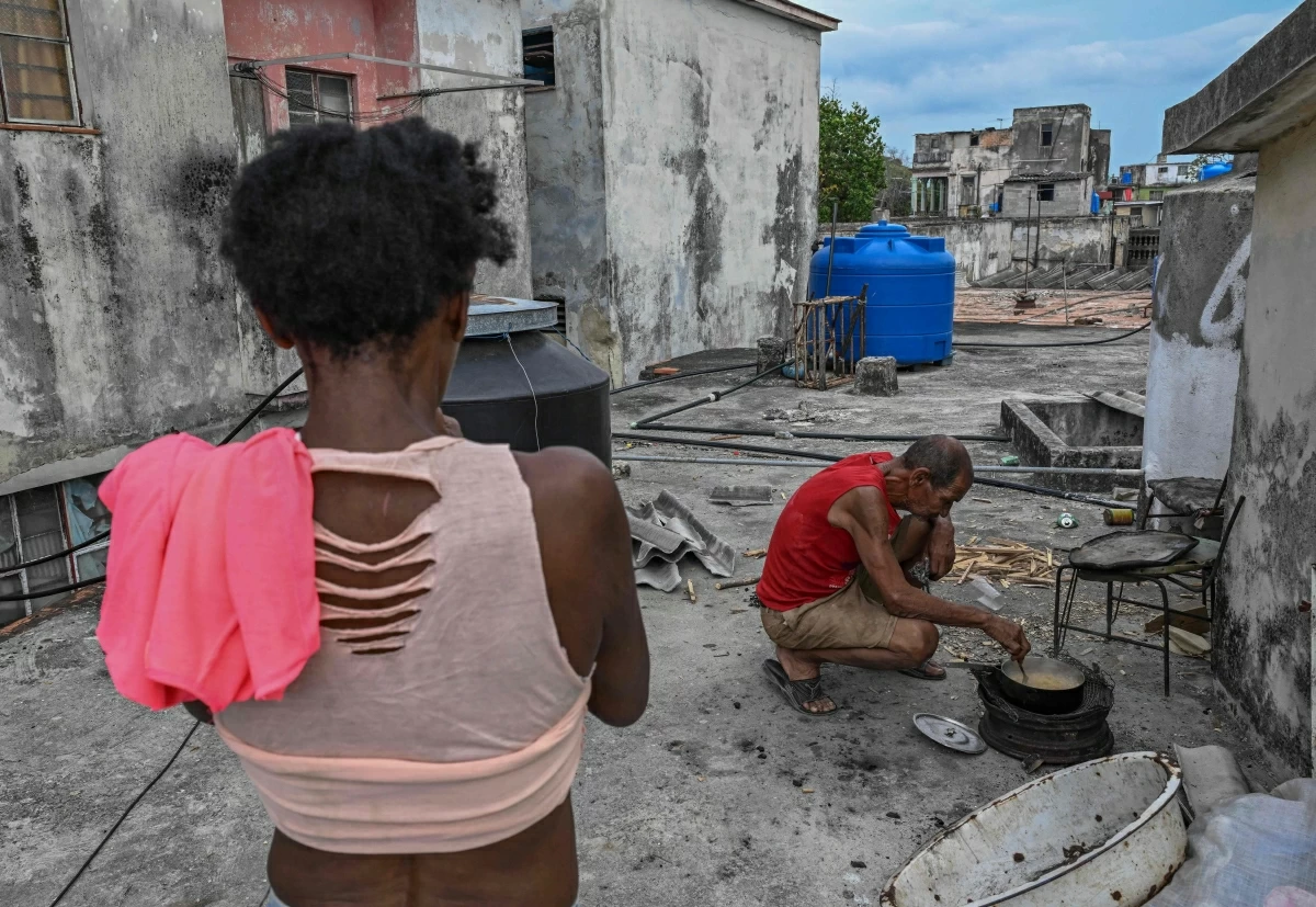 A man cooks with firewood during a blackout in Havana on Wednesday (AFP photo)