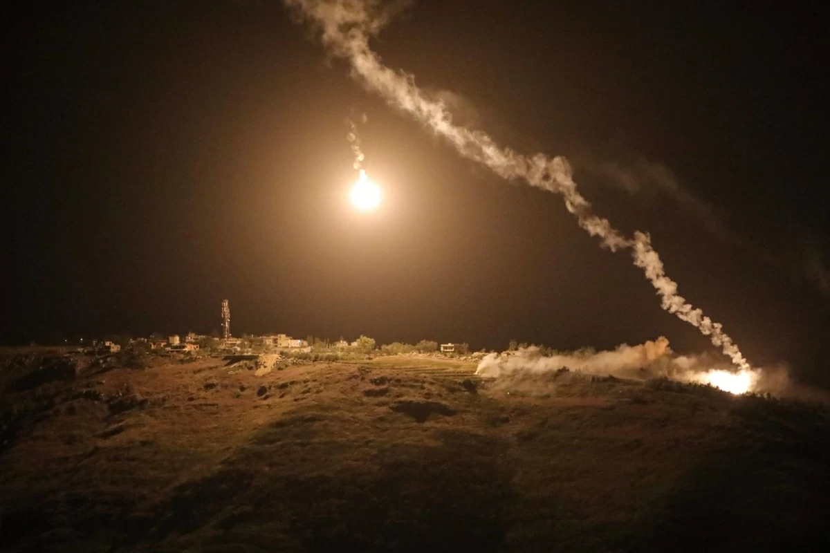 A photograph taken from the southern area of Marjayoun shows flares fired by the Israeli military descending over the village of Arnoun late on May 13, 2026 (AFP photo)