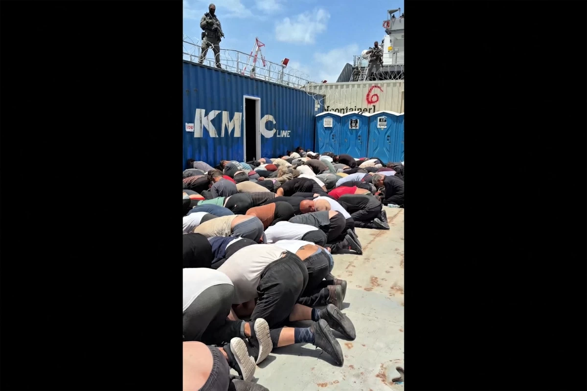 This screen grab taken from footage released on Israeli national security minister Itamar Ben Gvir’s X account on May 20, 2026 shows dozens of detained activists from the Gaza-bound aid flotilla kneeling with their hands tied behind their backs and their foreheads on the ground on the deck of a military boat in Israel (AFP photo)