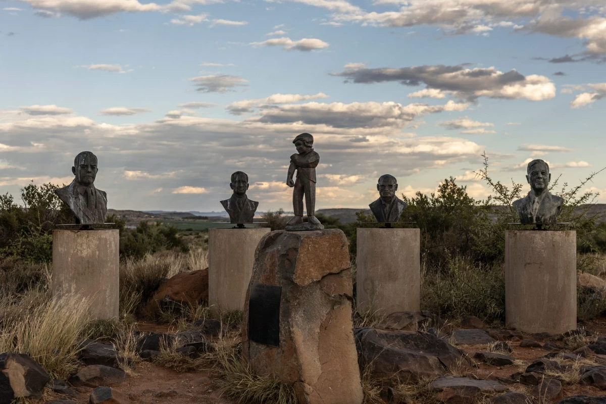 A bronze statue of the Kleinreus (C), also known as “Little Giant”, the symbol of Orania, is seen with several bronze busts of past Afrikaner leaders including Apartheid leaders in Orania, on January 28, 2026
(AFP photo)