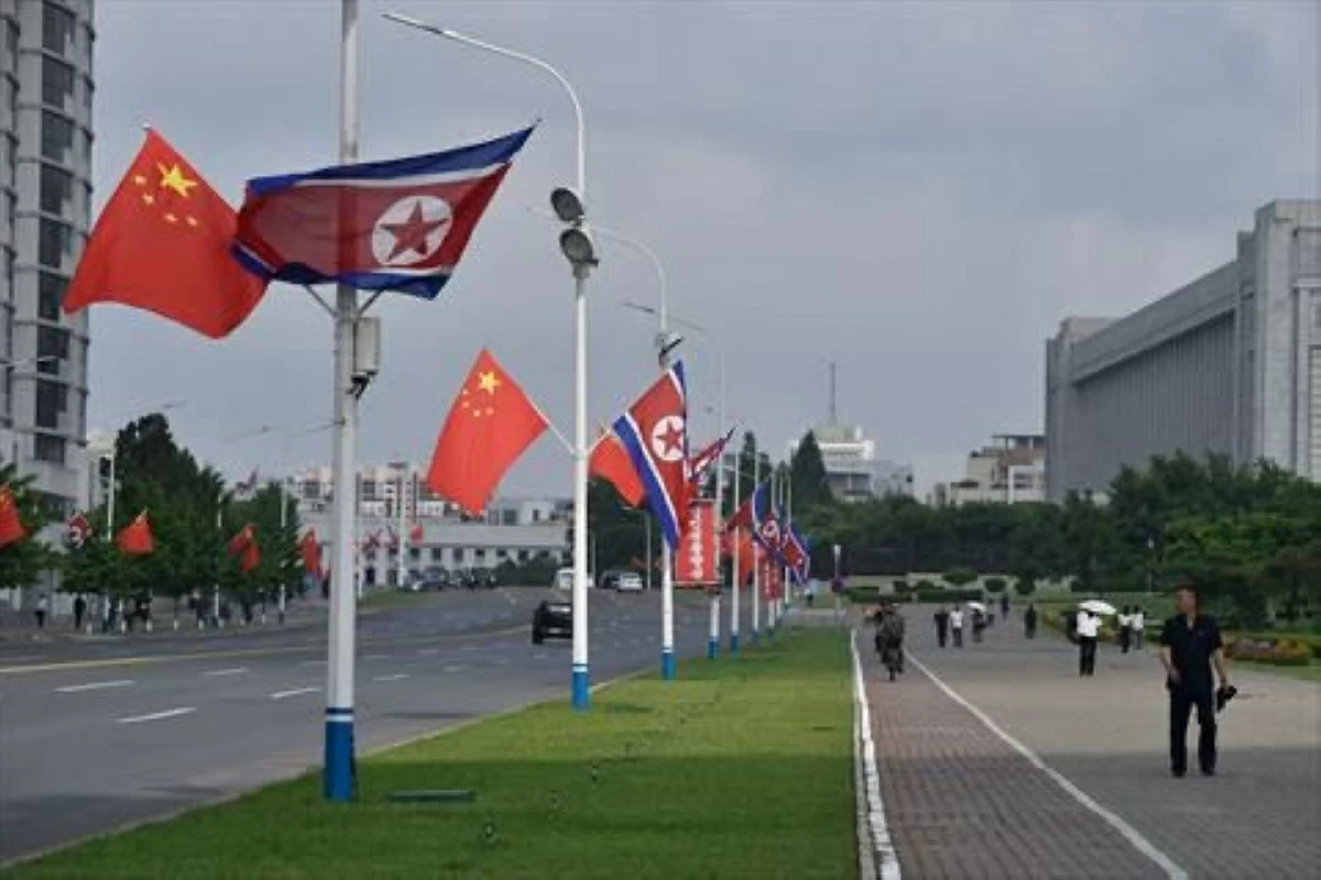 The national flags of North Korea and China are displayed on a street in Pyongyang on June 8, 2026 (AFP photo)