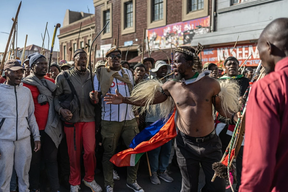 Nkosikhona ‘Phakelumthakathi’ Ndabandaba (third right) gestures as he gives instructions to the crowd during a protest march against undocumented migrants in Springs, Ekurhuleni, on Monday
(AFP photo)