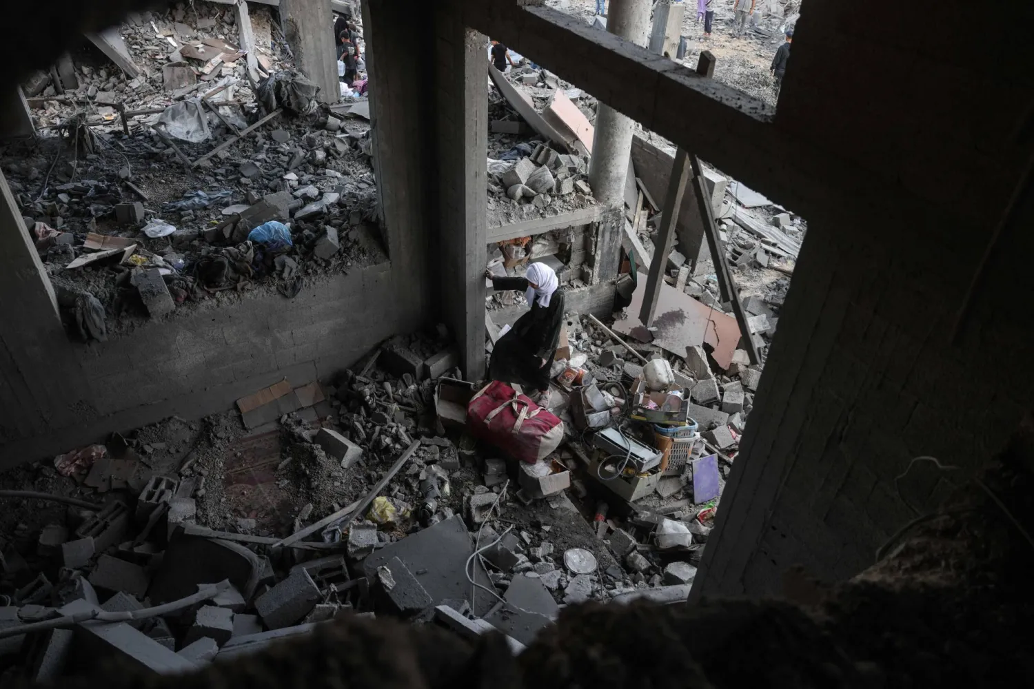 A Palestinian woman stands amid debris at the site of an Israeli airstrike in Khan Younis, southern Gaza Strip, on June 7, 2026. (AFP photo)
