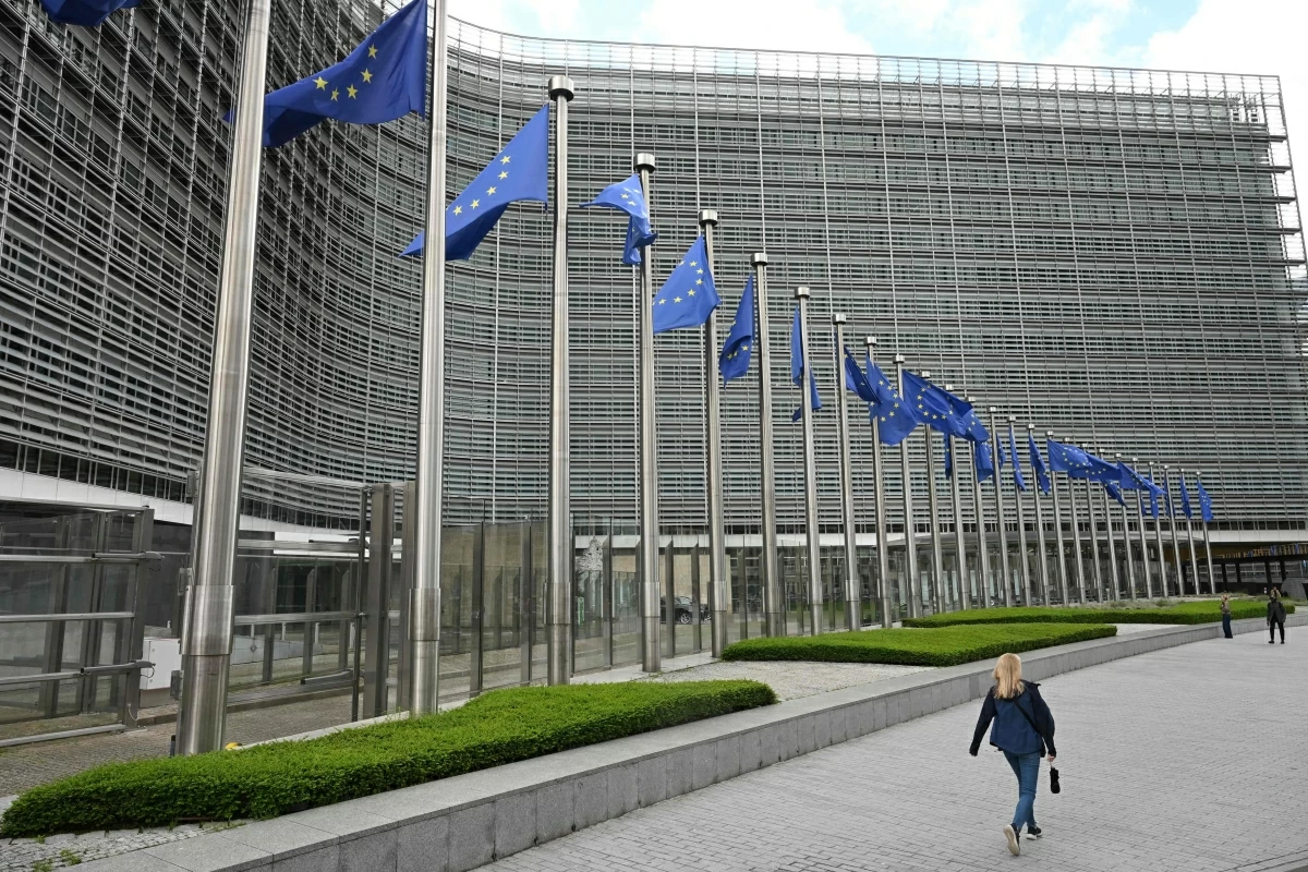 A pedestrian walks past the Berlaymont building, the EU Commission headquarters, in Brussels on June 9, 2026 (AFP photo)