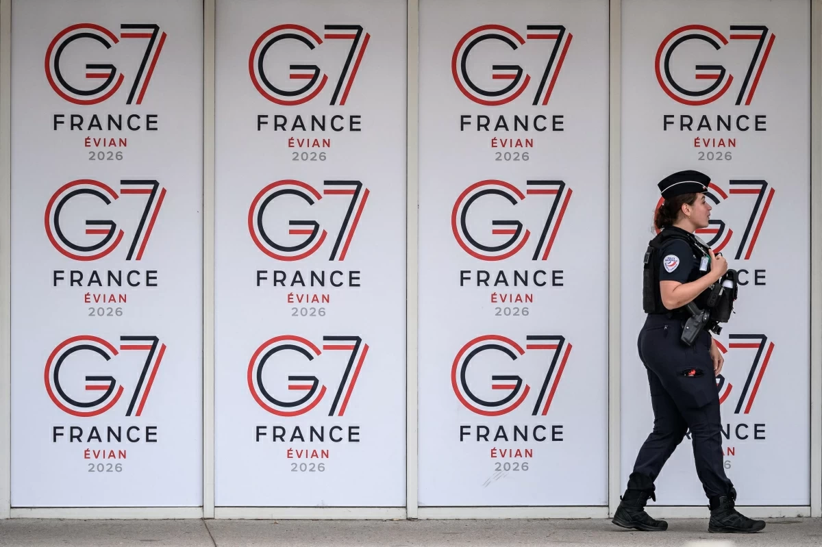 A police officer walks past logos of the G-7 summit in Evian, central-eastern France, on Wednesday (AFP photo)