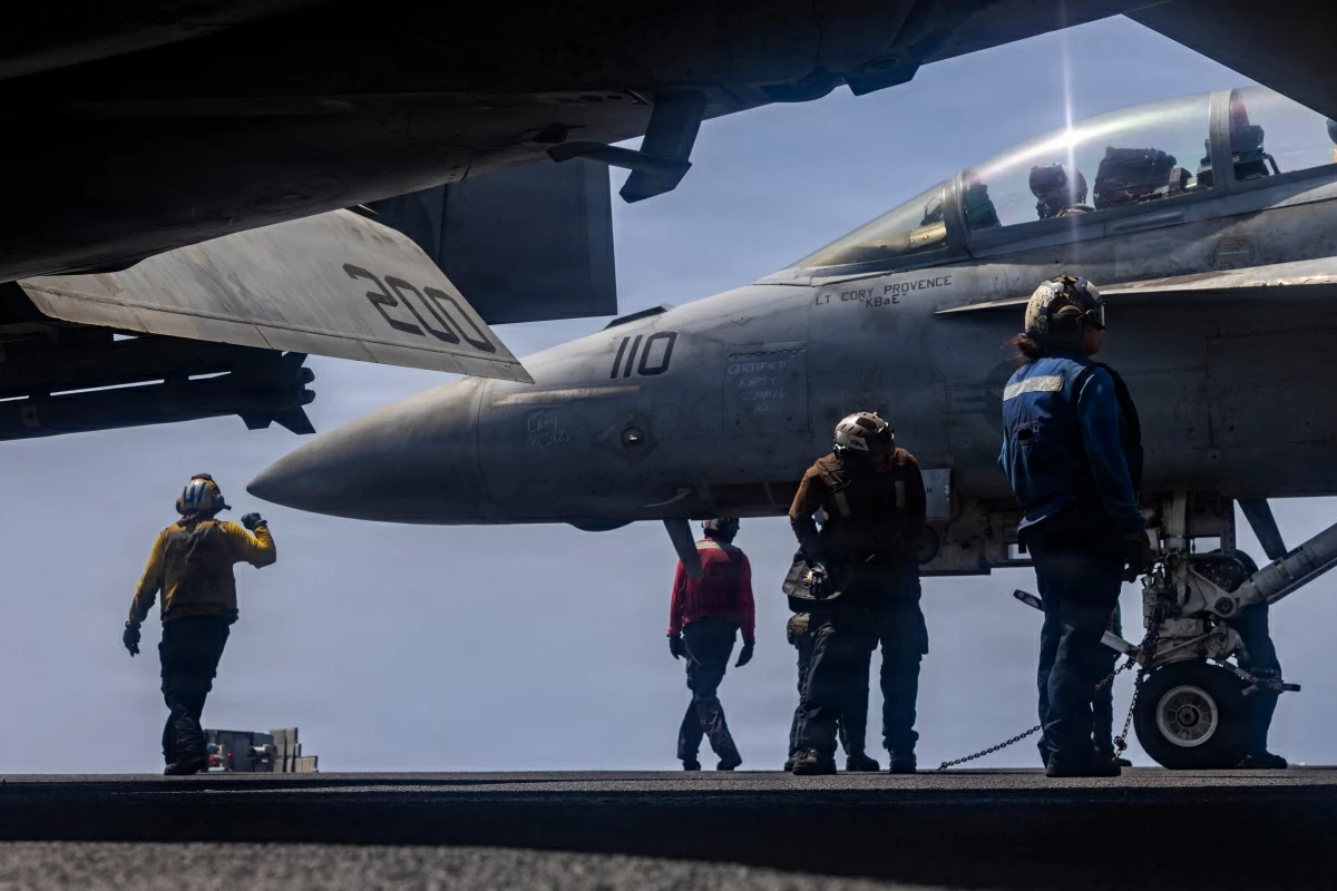 This US Navy handout photo released on May 28, 2026, by US Central Command Public Affairs shows US Sailors preparing to taxi an F/A-18F Super Hornet, attached to Strike Fighter Squadron (VFA) 41, on the flight deck of Nimitz-class aircraft carrier USS Abraham Lincoln on May 25, 2026 (AFP photo)