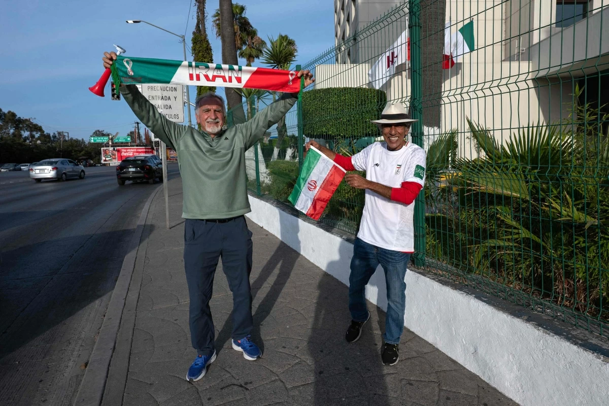 Iranian fans Mostafa Pourmand (left) and Reza Mansoor (R) pose for a photo outside the Iran's base camp at the Marriott Hotel in Tijuana, Mexico, on Tuesday
(AFP photo)