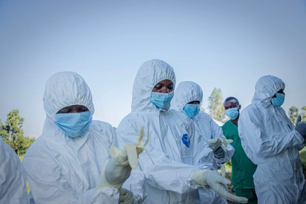 Volunteers put on their personal protective equipment before recovering the body of a 3-year-old child, presumed to have died of Ebola virus disease, in Bunia on June 11, 2026
(AFP photo)