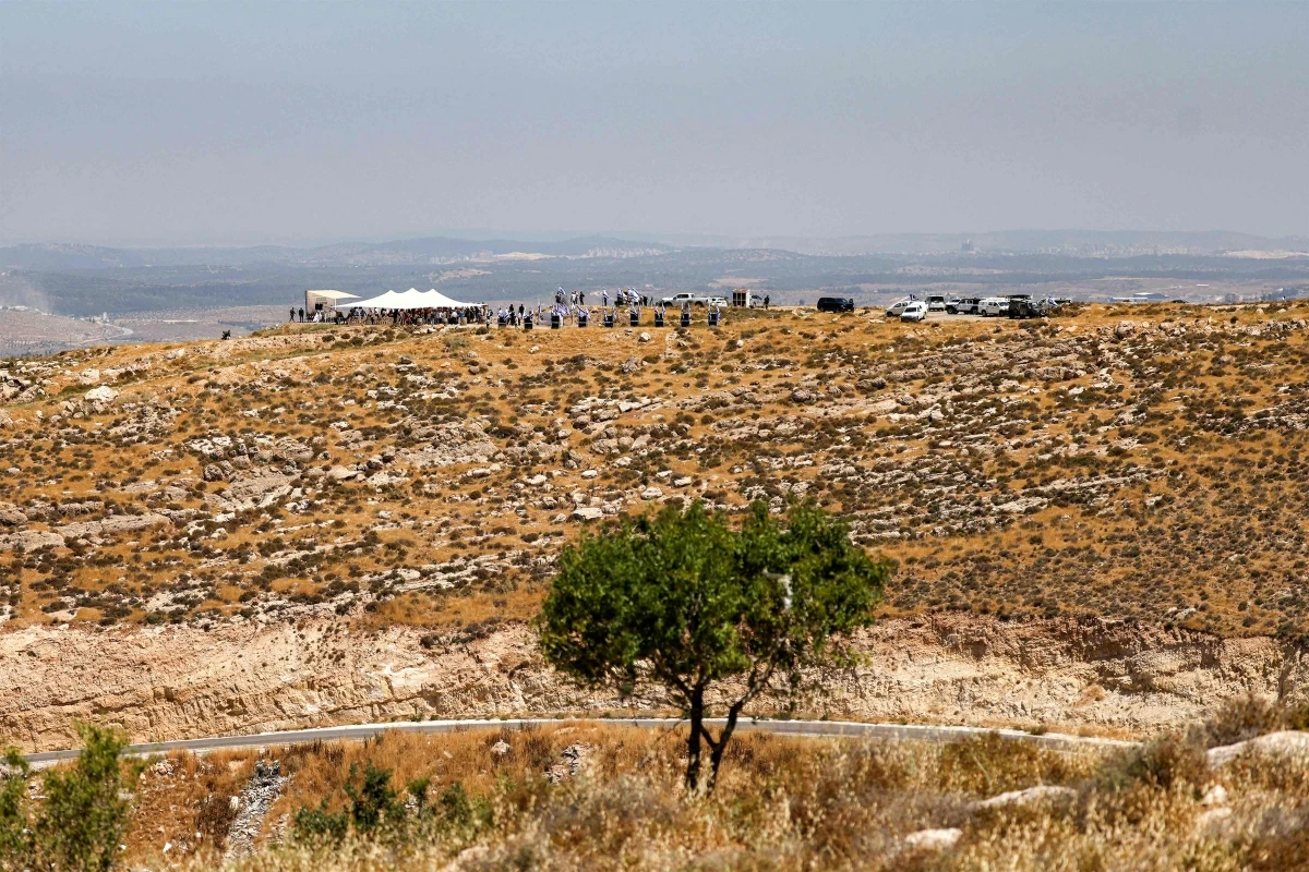 Israeli settlers, accompanied by Israel's far-right finance minister Bezalel Smotrich, gather during a cornerstone laying ceremony for a new settlement on Mount Tarousa, near the town of Dura west of Hebron in the occupied West Bank, on June 16, 2026
(AFP photo)