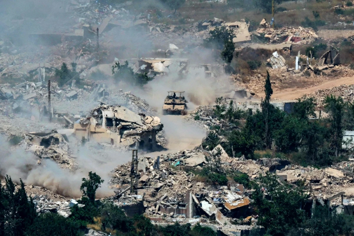 This picture taken from a position in the Upper Galilee in northern Israel, near the Israel-Lebanon border shows Israeli Merkava tanks driving along a road past destroyed buildings in southern Lebanon on June 17, 2026
(AFP photo)