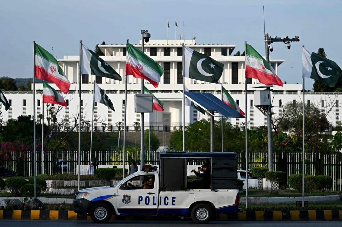 Police personnel ride past the national flags of Pakistan and Iran fluttering outside the President House in Islamabad on June 22, 2026 on the eve of Iran's President Masoud Pezeshkian's visit to Pakistan amid the US-Iran peace talks
(AFP photo)