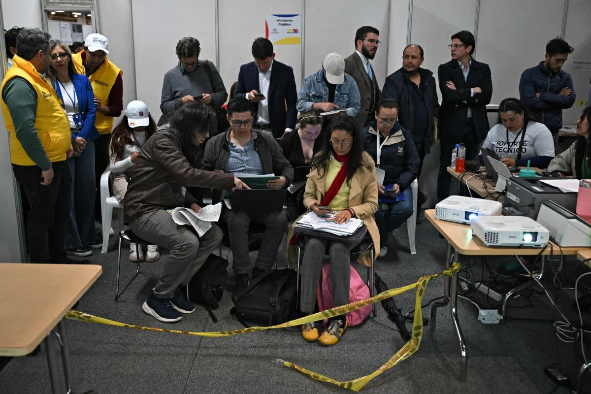 Delegates from the National Electoral Council (CNE), members of the Registrar’s Office, lawyers and observers take part in the vote count at Corferias, the largest polling centre in the country, the day after the presidential election runoff, in Bogota on Monday (AFP photo)