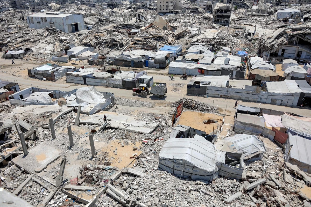 Tents and shelters are pictured next to rubble of collapsed buildings at a camp for people displaced by war in the Sheikh Radwan neighbourhood of Gaza City on Monday (AFP photo)