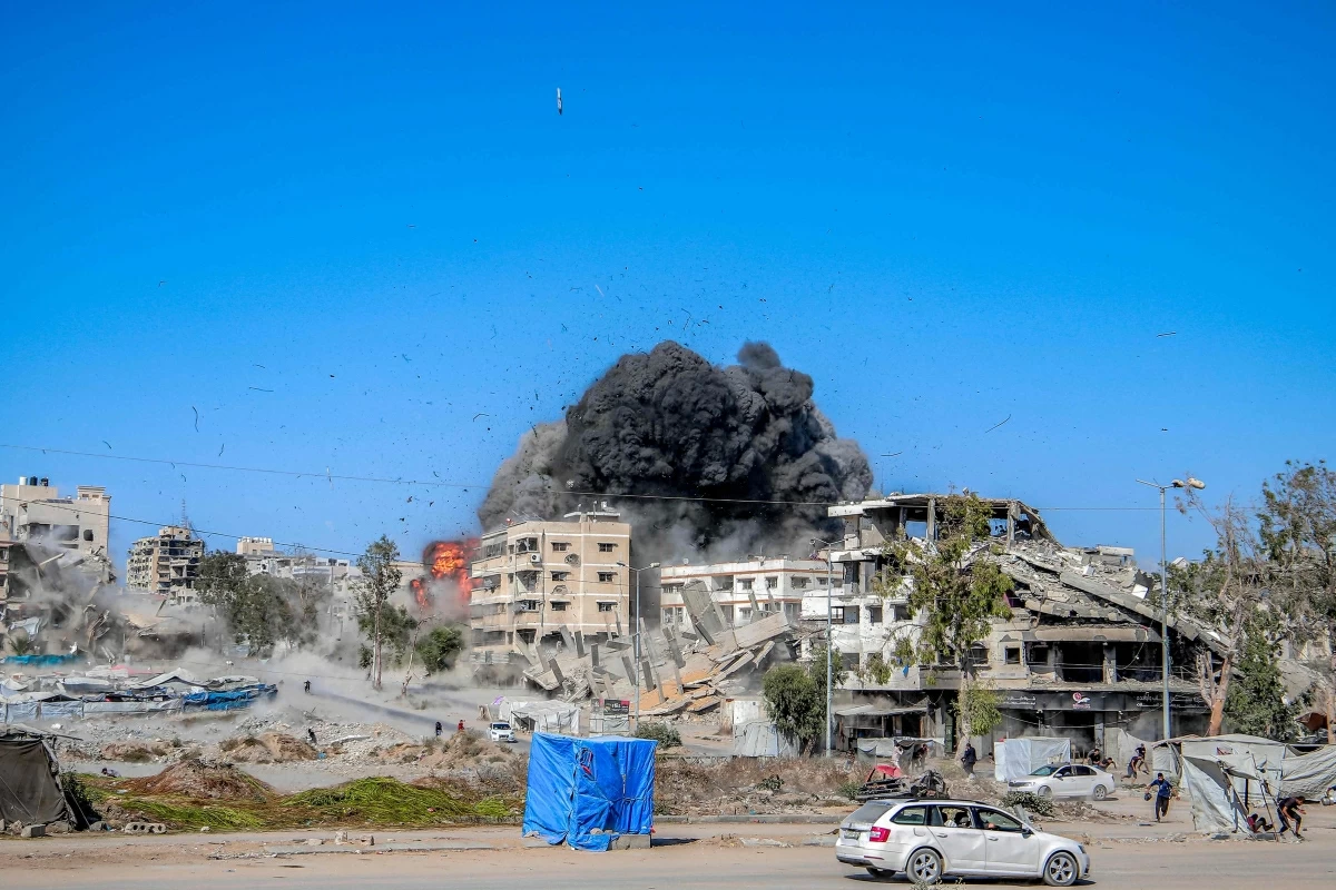 A projectile lands amidst other explosions during an Israeli strike on an industrial area in Gaza City on Sunday (AFP photo)