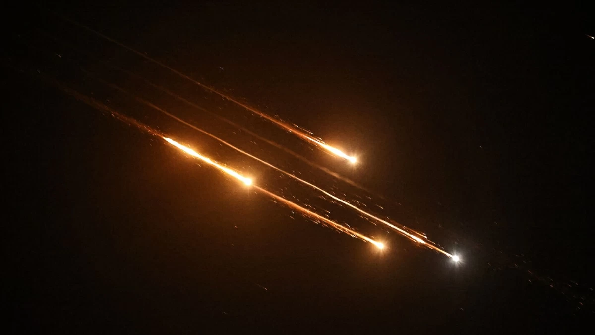 Debris of missiles fired from Iran toward Israel leave trails in the night sky over Nablus in the occupied West bank after being intercepted on June 13, 2025 (AFP photo)
