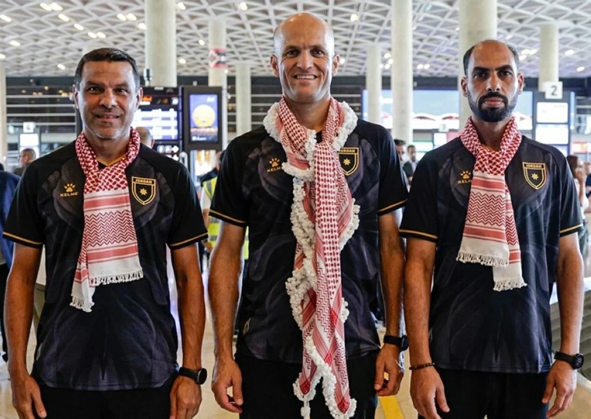 Referee Adham Makhadmeh (centre) with his colleagues upon their return to Amman following the 2026 World Cup (JFA photo)