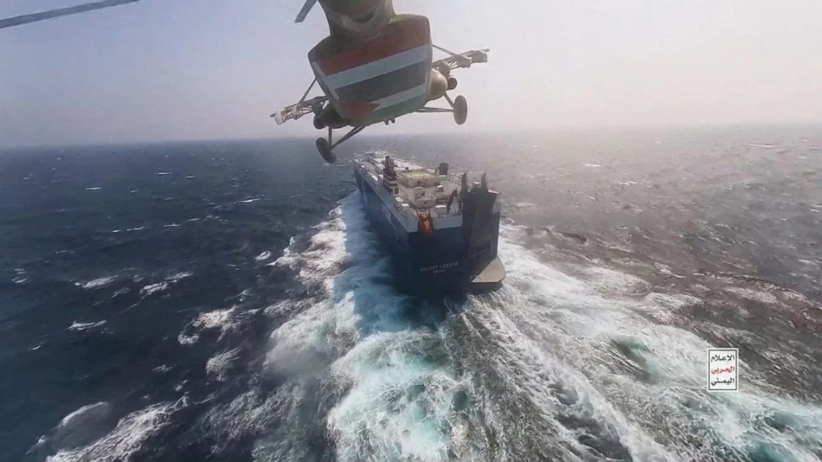 A Houthi military helicopter flies over the cargo ship 