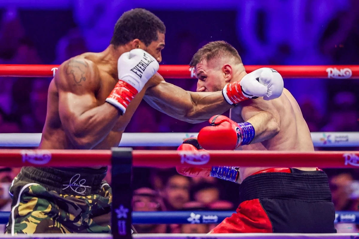 Britain's Anthony Joshua (left) and Albania's Kristian Prenga trade blows during their heavyweight boxing fight at the Jeddah Superdome in Jeddah on Sunday (AFP photo)