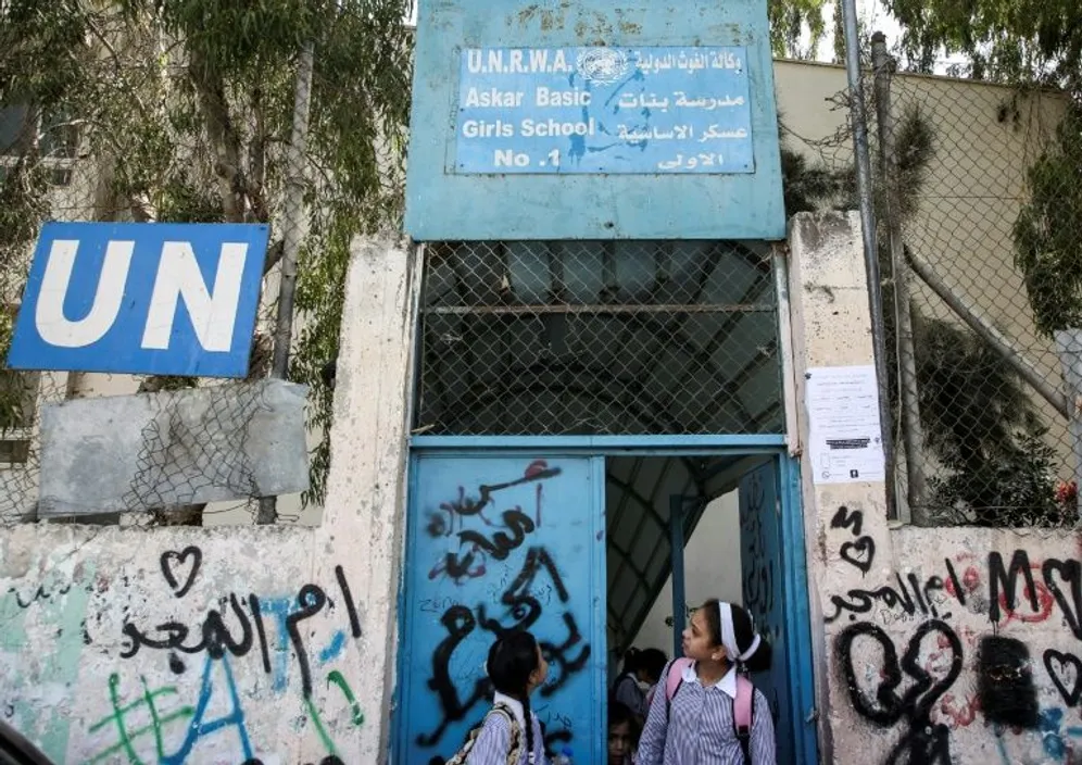 Palestinian girls outside a school run by UNRWA in the Askar refugee camp east of Nablus in the West Bank on September 2, 2018 (AFP photo) 