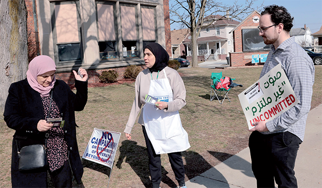   Volunteers ask voters to vote uncommitted and not to vote for President Joe Biden outside of Maples School in Dearborn, Michigan, on Tuesday (AFP photo)