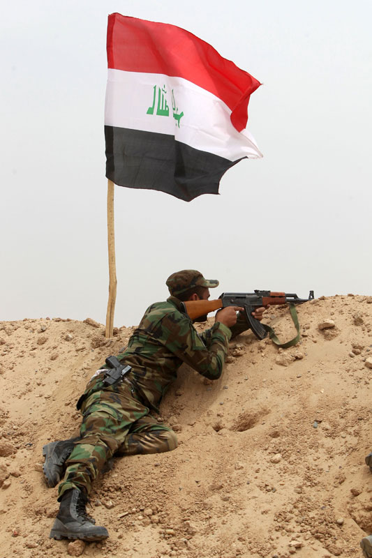 An Iraqi Shiite fighter from a Popular Mobilisation Units holds a position on the edge of Anbar province, 120km northwest of Baghdad, on Monday (AFP photo)