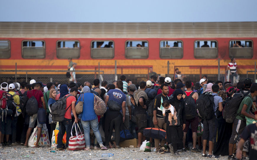 Migrants wait to board a train after crossing the border between the former Yugoslav Republic of Macedonia and Greece near Gevgelija on Saturday (Reuters photo)
