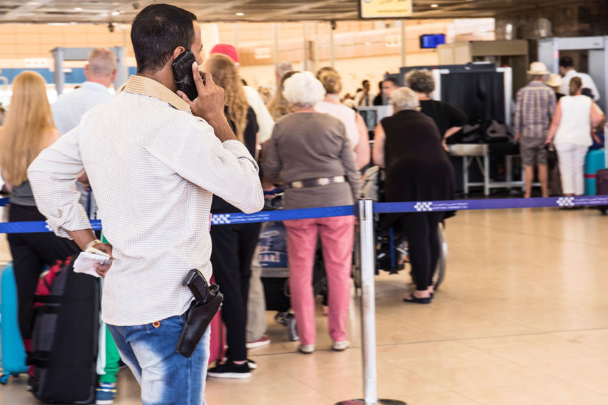 A security officer talks on his phone in front of the luggage screening section at the airport of Sharm El Sheikh, Egypt, Saturday (AP photo)