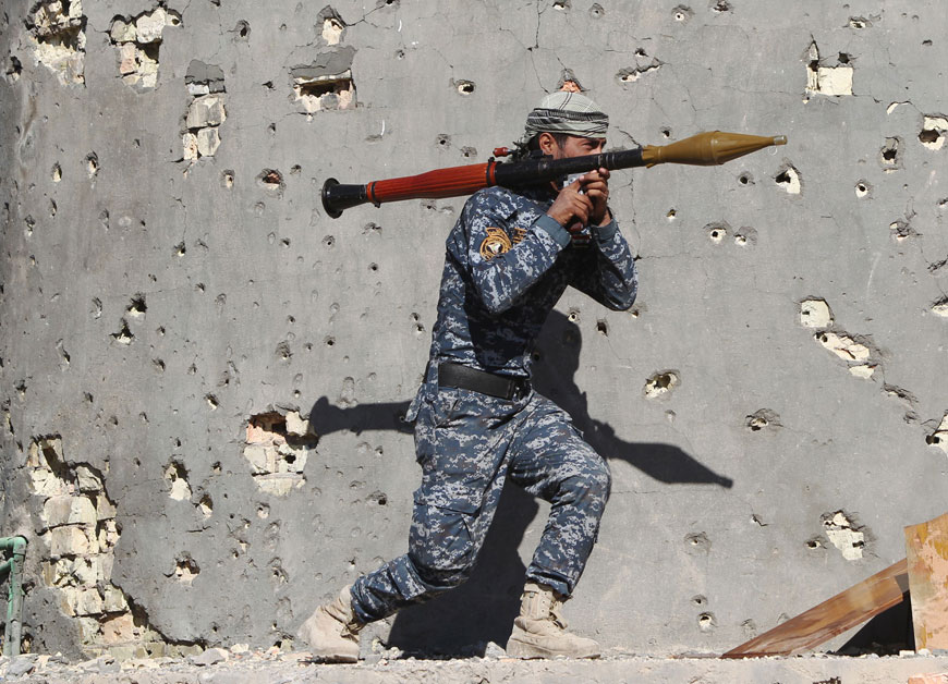 An Iraqi security forces member takes combat position as he carries an RPG in the rural town of Husayba in the Euphrates Valley, seven kilometres east of Ramadi, on Monday (AFP photo)