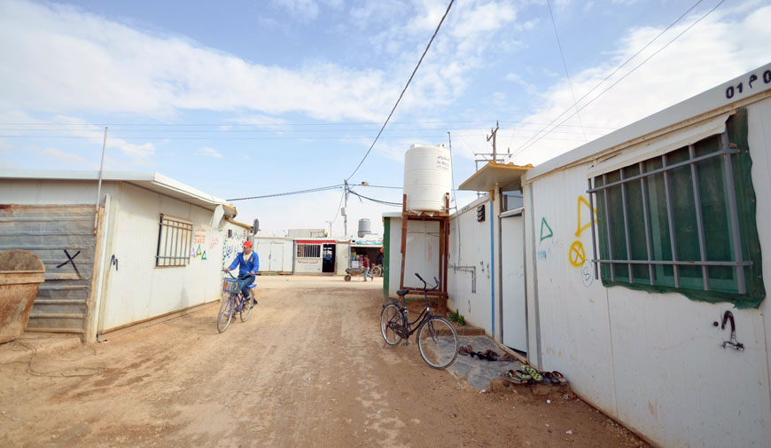 A Syrian refugee rides a bicycle at the Zaatari Refugee Camp, some 90km northeast of Amman, in late February (Photo by Muath Freij)