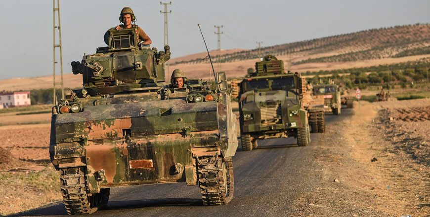 This photo taken on September 2, 2016 shows Turkish soldiers standing in a Turkish army tank driving back to Turkey from the Syrian-Turkish border town of Jarabulus in the Turkish-Syrian border town of Karkamis (AFP photo)