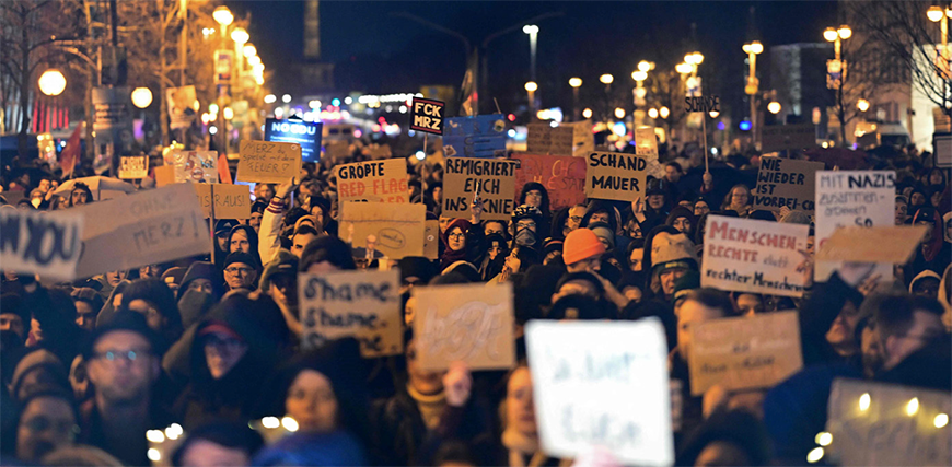 Demonstrators hold up placards in front of the Konrad Adenauer Building, headquarters of Germany's Christian Democratic Union (CDU) Party, in Berlin on Thursday (AFP photo)