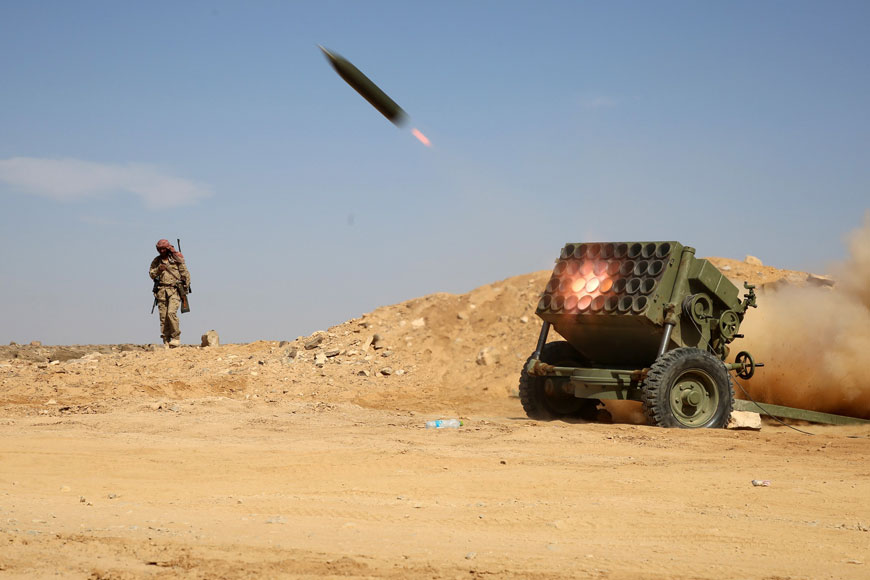 Armed Yemeni tribesmen from the Popular Resistance Committees, supporting forces loyal to Yemen’s President Abed Rabbo Mansour Hadi, fire as they hold a position in the area of Sirwah, west of Marib city, on Friday (AFP photo)