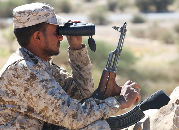 A soldier loyal to Yemen’s government uses binoculars as he takes position near Al Jadaan area, which was taken by the pro-government army from Houthi rebels, in the country’s central province of Marib, on Monday (Reuters photo)