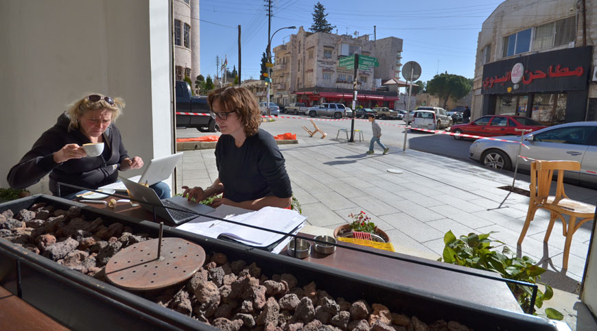 Two foreigners work on their laptops in Rumi Café in Jabal Luweibdeh, Amman, Wednesday (Photo by Muath Freij)