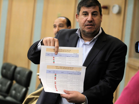 Deputy Yihya Saud holds a copy of a Lower House session's schedule on Tuesday (Photo by Osama Aqarbeh)