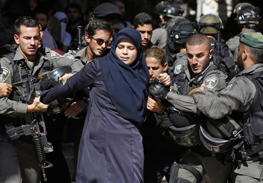 Israeli forces arrest a Palestinian woman during clashes between Palestinian protesters and Israeli forces after authorities limited access for Muslim worshippers to the flashpoint Al Aqsa Mosque compound in the Old City of Jerusalem on Sunday (AFP photo)
